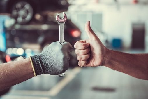 people giving the thumbs up with a wrench
