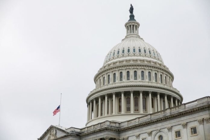 The U.S. flag flies over the U.S. Capitol in Washington