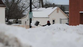 BUFFALO, NY - DECEMBER 28: A man clears his sidewalk along South Park Avenue on December 28, 2022 in Buffalo, New York.  Historic winter storm Elliott dumped up to four feet of snow on the area, leaving thousands without power and thirty confirmed dead in the city of Buffalo and surrounding suburbs.  John Normile/Getty Images/AFP (Photo by John Normile / GETTY IMAGES NORTH AMERICA / Getty Images via AFP)