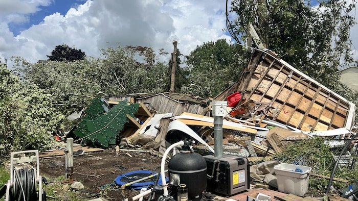 The remains of a wooden structure with some scattered objects.