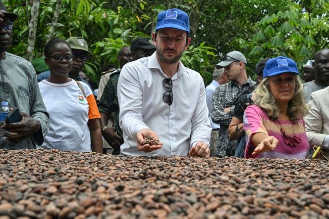 EU Commissioner Virginijus Sinkevičius (centre) during a visit to a farm near Agboville, south-eastern Ivory Coast, on April 7, 2024.