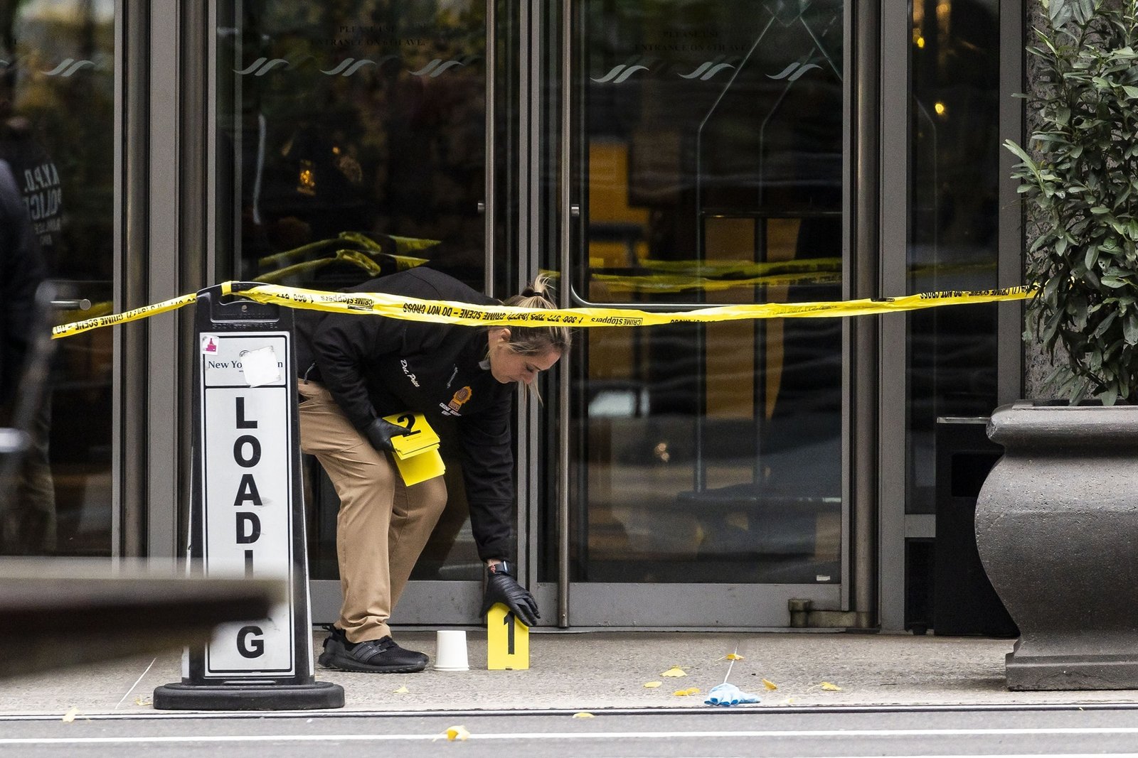 PHOTO: A member of the New York Police Department's Crime Scene Unit at the scene where UnitedHealthcare CEO Brian Thompson was shot and killed in New York on December 4, 2024.